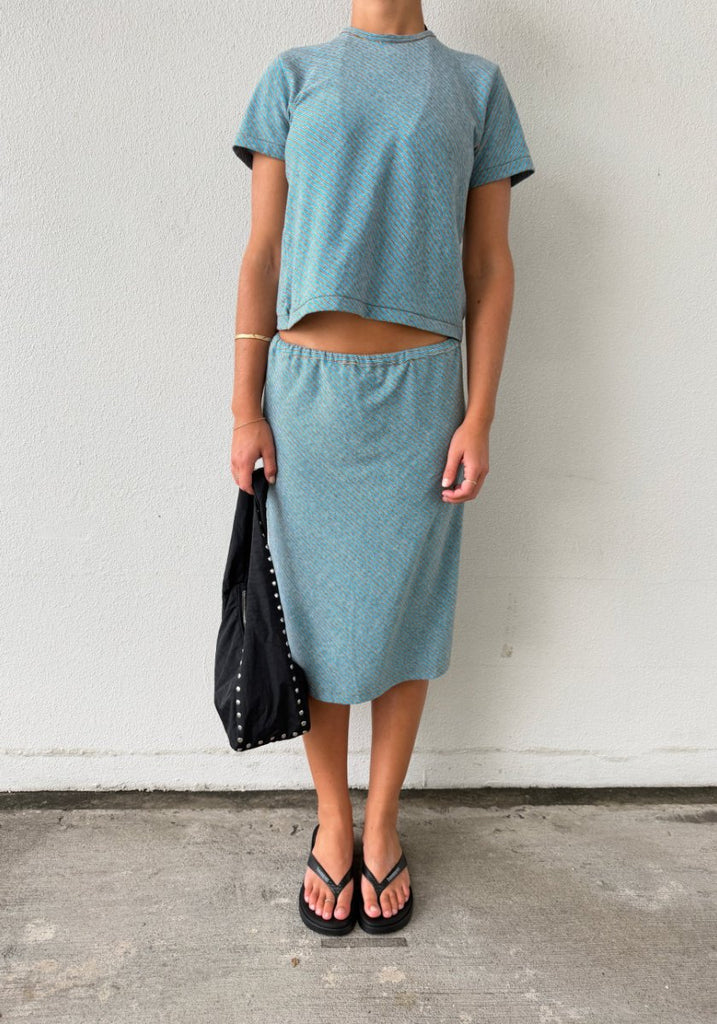 Bassike Bias Stripe Skirt worn with matching Bias Stripe Baby T-Shirt in Blue/Brown Stripe, full length front view