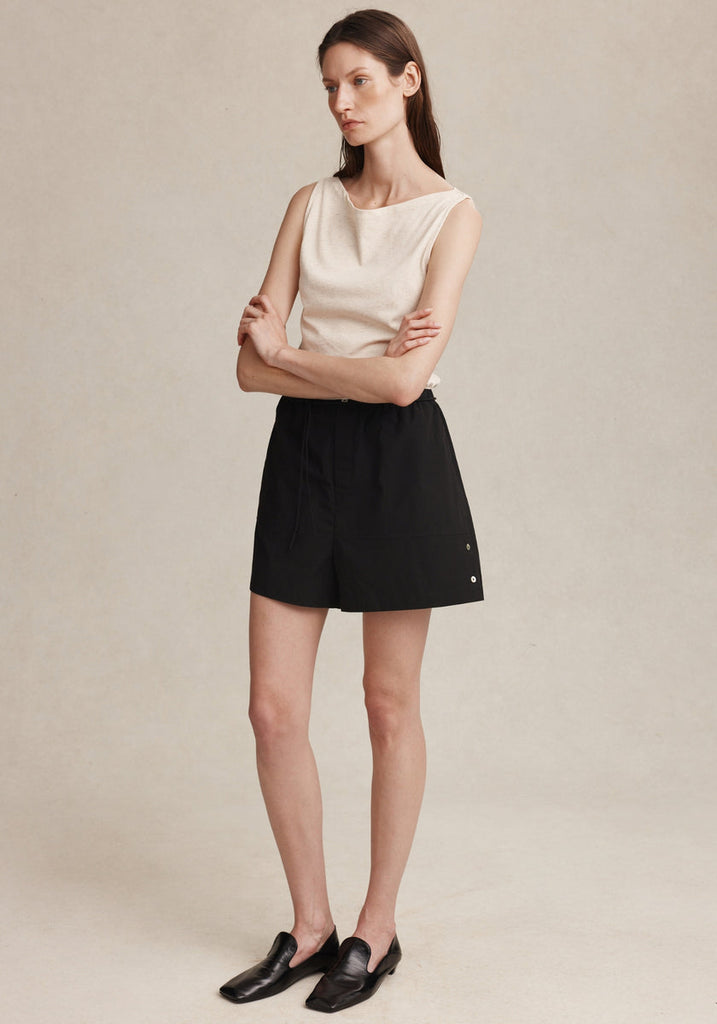 Marle Diya Short in Black worn on model, front view with arms crossed