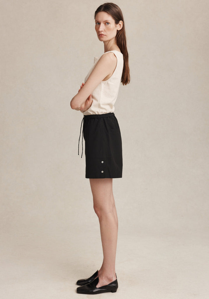Marle Diya Short in Black worn on model, side view showing drawstring and side buttons