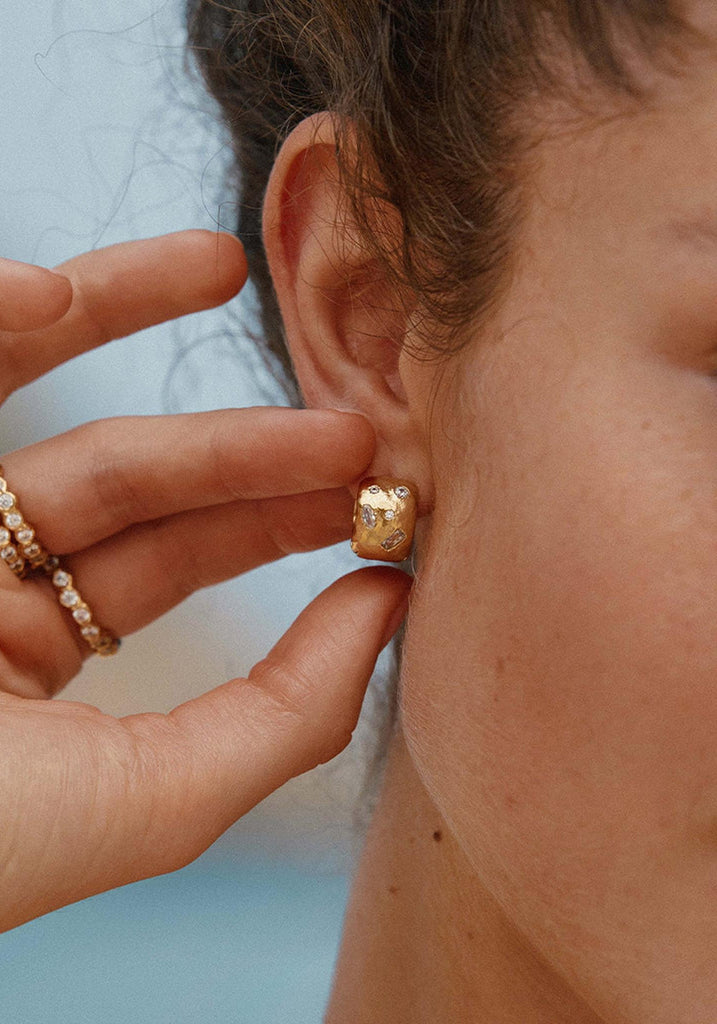 Agapée Lucci Earrings hammered huggie hoop worn on ear