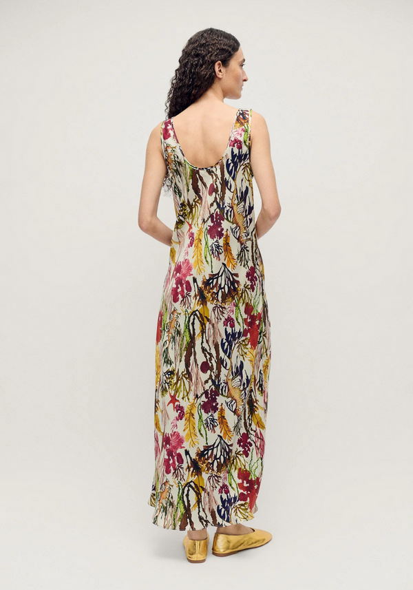 Woman wearing a floral dress on a plain background