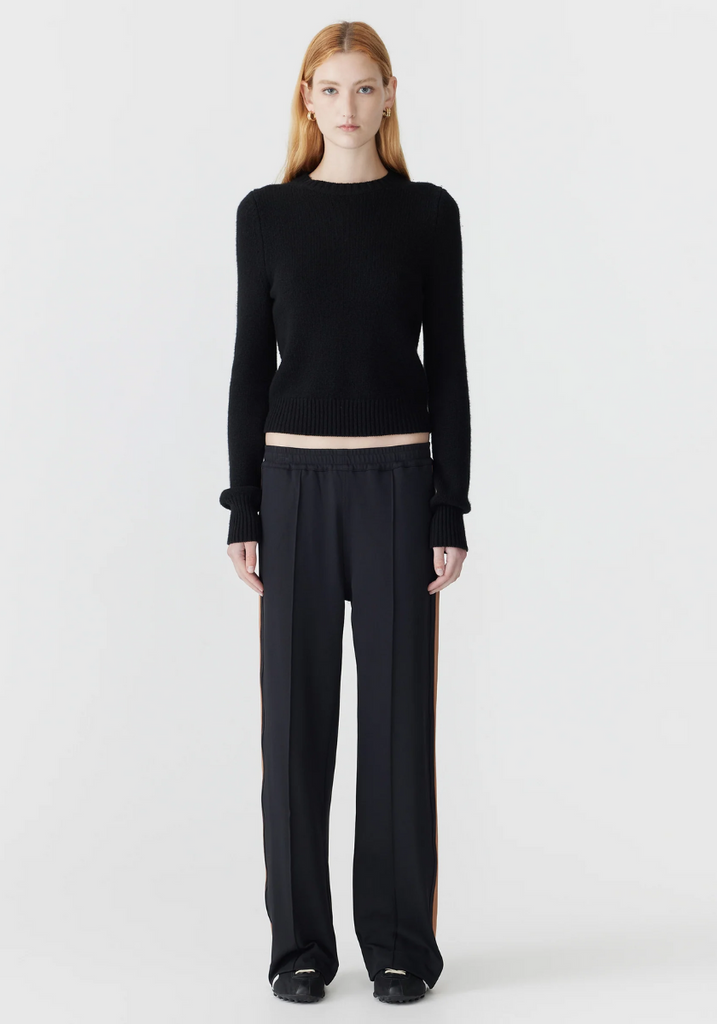 Person wearing a black outfit on a white background
